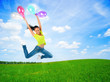 happy jumping young woman with balloons outdoor