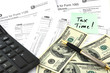 Tax Time. Concept Image with calculator, money and tax return fo