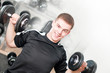 Young man lifting dumbbells in sport club. White background Young man lifting dumbbells in sport club. White background