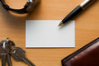 Blank white card in a workplace with business tools