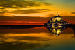 Mont Saint Michel abbaye reflected in the bay at sunset, France
