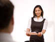 An asian woman giving her resume to a man at a job interview An asian woman giving her resume to a man at a job interview