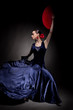 young woman dancing flamenco on black