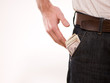 A man putting american money in his pants pocket A man putting american money in his pants pocket