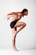 young male dancer posing over grey background young male dancer posing over grey background