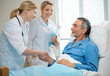 doctor shakes hands with patient in hospital bed doctor shakes hands with patient in hospital bed