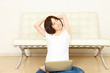 young woman sitting on floor and using laptop