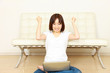 young woman pleased by something on her computer screen