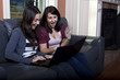 Two Young woman using laptops
