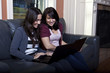 Two Young woman using laptops