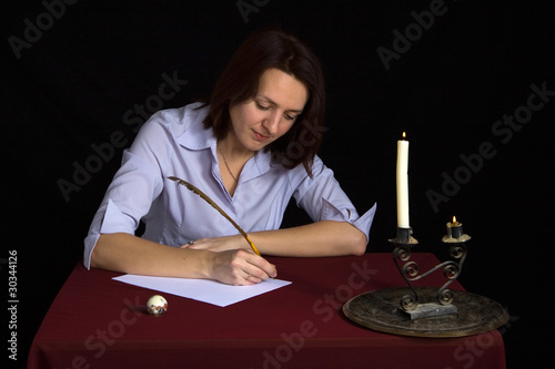 Photo: portrait of beautiful brown-haired girl writing work portrait of beautiful brown-haired girl writing work