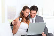 Photo: Bride and groom doing shopping on inernet at home Bride and groom doing shopping on inernet at home