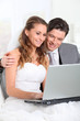 Photo: Bride and groom surfing on internet Bride and groom surfing on internet