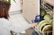 Young woman in kitchen doing housework. Young woman in kitchen doing housework.
