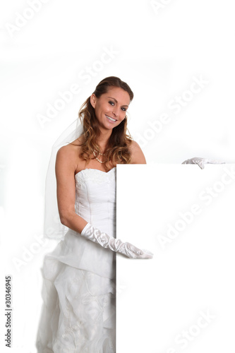 Photo: Beautiful smiling bride holding whiteboard Beautiful smiling bride holding whiteboard