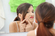 Young teenage woman with pimple