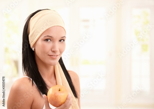 Photo: Attractive woman smiling with apple Attractive woman smiling with apple