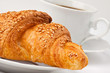 Breakfast: coffee and croissant with sesame seeds