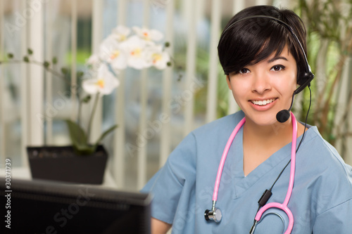 Photo: Attractive Multi-ethnic Woman Wearing Headset, Scrubs and Stetho Attractive Multi-ethnic Woman Wearing Headset, Scrubs and Stetho