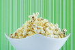 Freshly popped popcorn in a white bowl Freshly popped popcorn in a white bowl