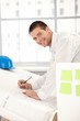 Happy young architect working in office