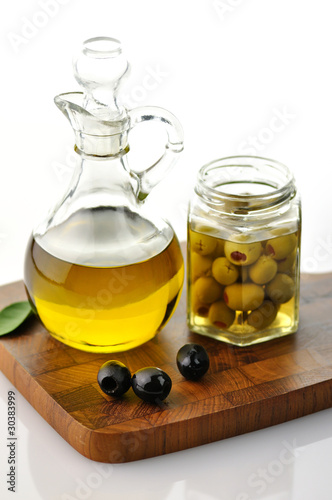 Photo: A bottle of olive oil with olives A bottle of olive oil with olives