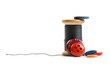 Thread bobbin and buttons isolated on white background