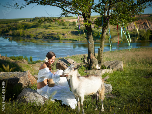 Photo: young woman herding goats young woman herding goats