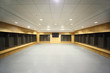 large clean locker room. gray floor and ceiling, big televisor large clean locker room. gray floor and ceiling, big televisor