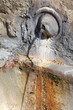 fountain in Vatican wall, thin jet of water; ancient masonry fountain in Vatican wall, thin jet of water; ancient masonry