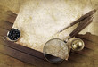 Compass and magnifier on textured paper
