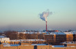 Roofs under snow and pipe with smoke