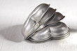 heart cake tin trays stacked on white wood table heart cake tin trays stacked on white wood table