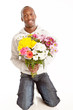 Handsome smiling young black man presenting flowers