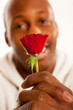 Marriage Proposal with engagement ring on single red rose