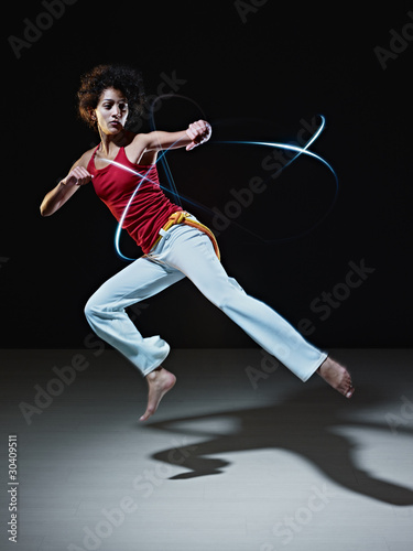 Photo: hispanic woman playing capoeira martial art hispanic woman playing capoeira martial art