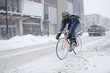 Bicycle courier in winter snow storm