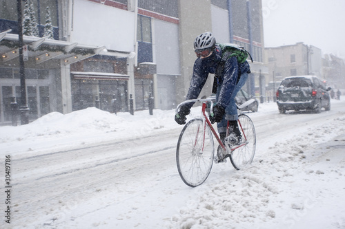 Photo: Bicycle courier in winter snow storm Bicycle courier in winter snow storm
