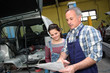 Portrait of professional and teenager in apprenticeship Portrait of professional and teenager in apprenticeship