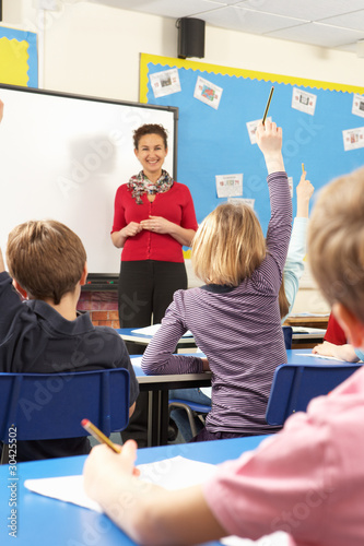 Photo: Schoolchildren Studying In Classroom With Teacher Schoolchildren Studying In Classroom With Teacher