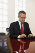 businessman typing on touch pad computer