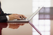 businessman typing on laptop computer