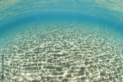 Photo: Ripples of sunlight reflected on the sandy ocean floor. Ripples of sunlight reflected on the sandy ocean floor.