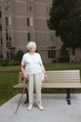 Senior woman waiting at a bus stop Senior woman waiting at a bus stop