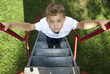Foto: Boy climbing a slide in a park Boy climbing a slide in a park