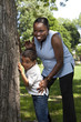 Mother and son playing hide and seek at a park Mother and son playing hide and seek at a park