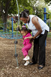 Mother and daughter playing at a park Mother and daughter playing at a park