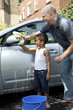 Foto: Father and son washing a car Father and son washing a car