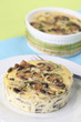 Mushroom gratin with eggs and cheese, garnished with parsley Mushroom gratin with eggs and cheese, garnished with parsley