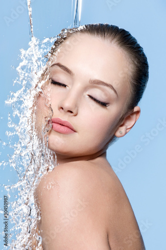 Beautiful teen under splash of water